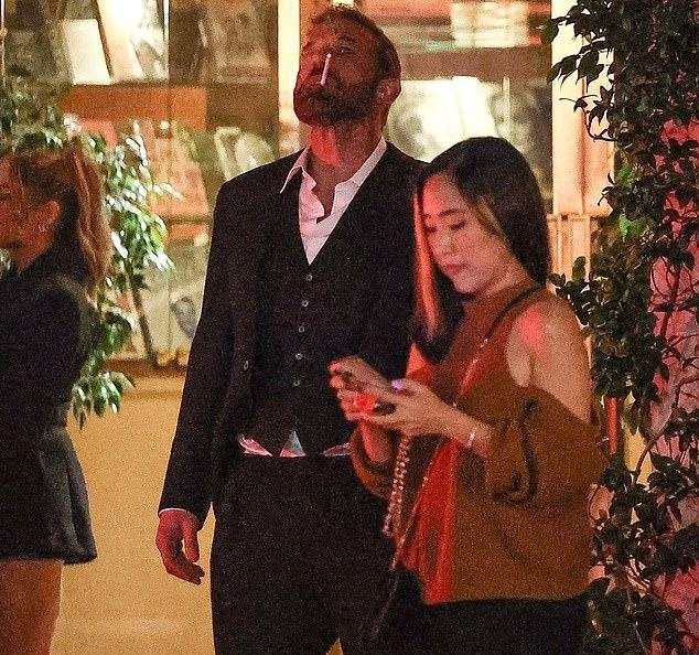 Бен Аффлек запрокинул голову, предаваясь курению сигареты возле отеля Sunset Tower в Голливуде, в момент, который, несомненно, станет очередным мемом