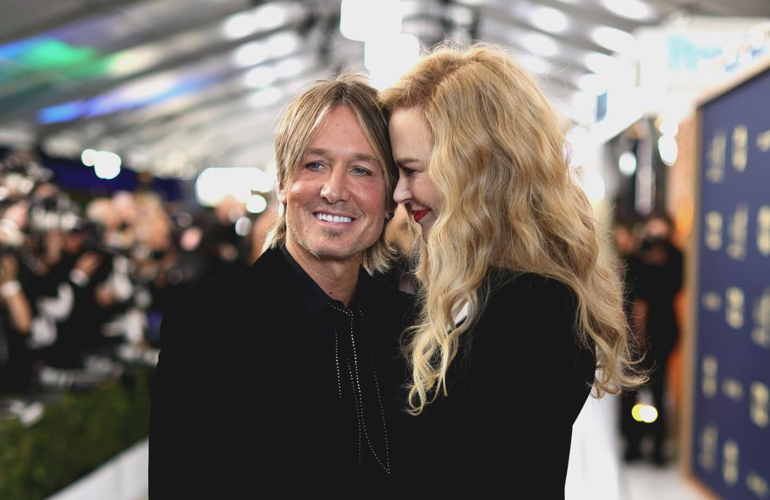 Улыбающийся в камеру Кит Урбан, рядом со смеющейся Николь Кидман.