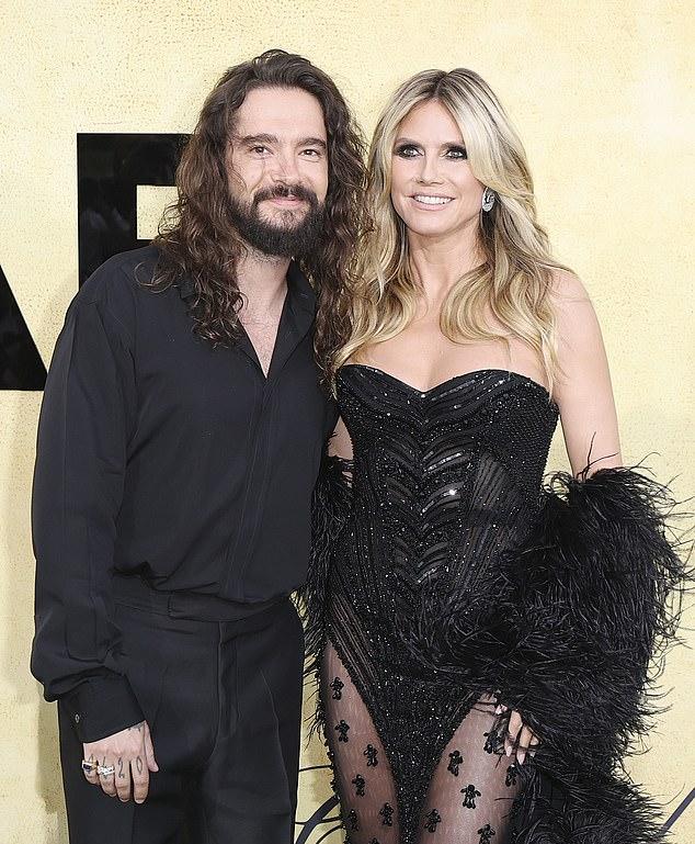 Heidi Klumturned up the heat while posing topless on the beach on Wednesday